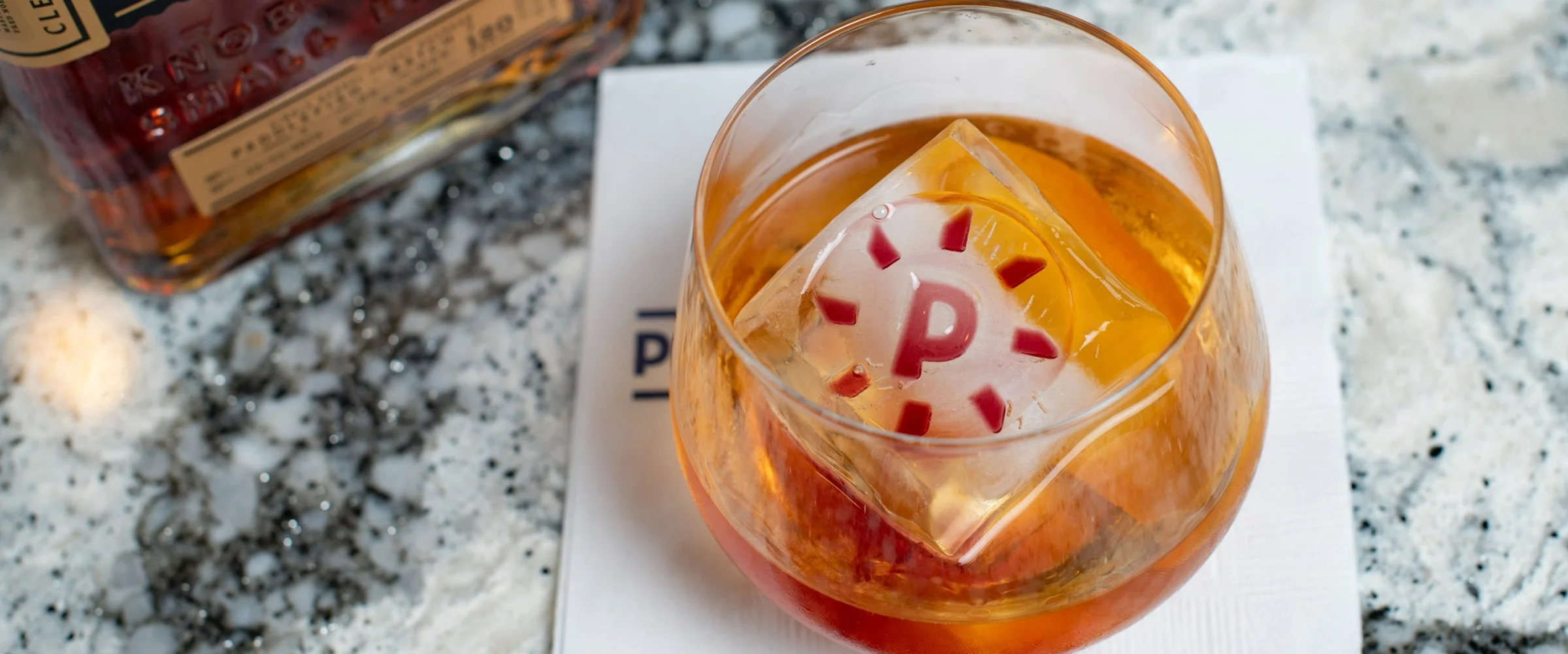 cocktail with Paddlefish-branded ice cube - desktop version